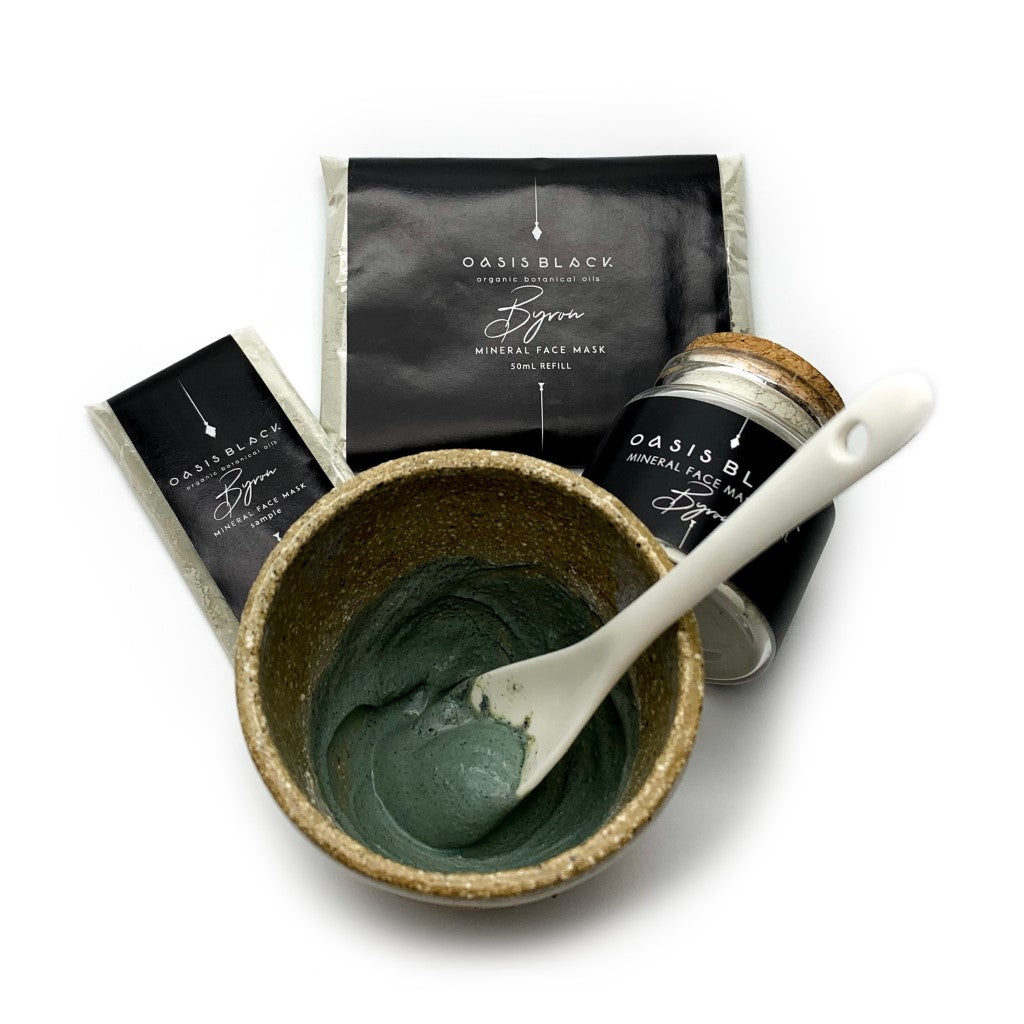 All available sizes of Oasis Black's Powdered Clay Mud Mask in Byron, sitting behind the activated green paste in a clay bowl. Byron is a stormy turquoise coloured mask activated with water and featuring French Green Clay, Spirulina, Blue Butterfly Pea Flower, Lemon Myrtle and Black Seeds. Available exclusively from Oasis Black - makers of All Natural and Organic Botanical Skincare featuring Black Seeds (Nigella Sativa). Handmade in small batches to waterless formulations in the Byron Bay Hinterland. 