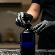 Person screwing a black pump cap onto a blue bottle containing Oasis Black's Face & Body, Powder to Liquid Cleanser Concentrate in HEMP. Oasis Black's Cleanser Concentrates are All natural, zero waste castile soap based powdered cleansers that turn into liquid face and body wash with water. Available exclusively from Oasis Black - makers of All Natural and Organic Botanical Skincare featuring Black Seeds (Nigella Sativa). Handmade in small batches to waterless formulations in the Byron Bay Hinterland.